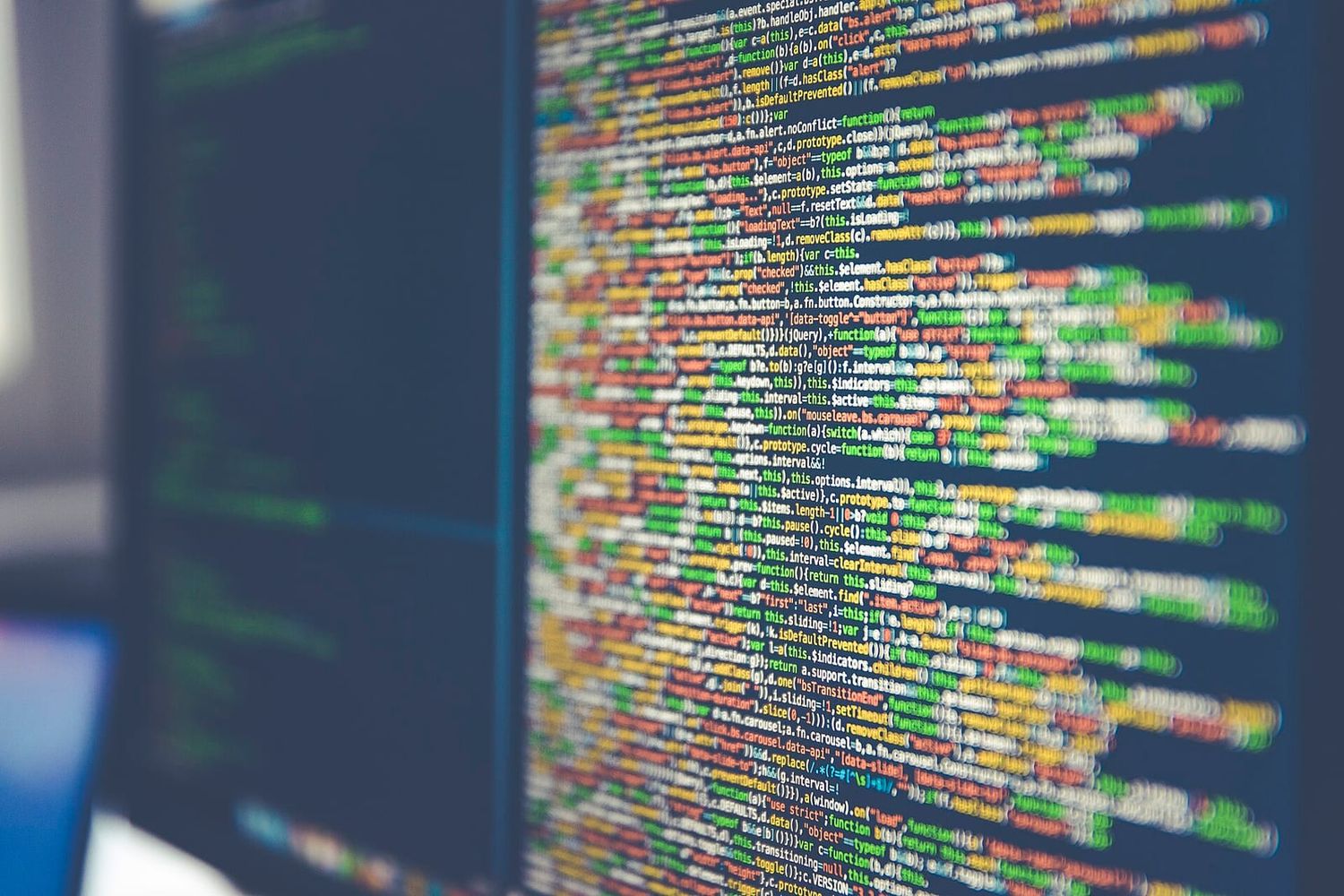 Bildschirm mit farbig hervorgehobenem Programmcode, leicht unscharf aus schrägem Winkel